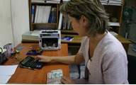 women typing on a calculator