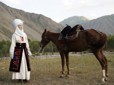 Woman with her horse in Kyrgyzstan