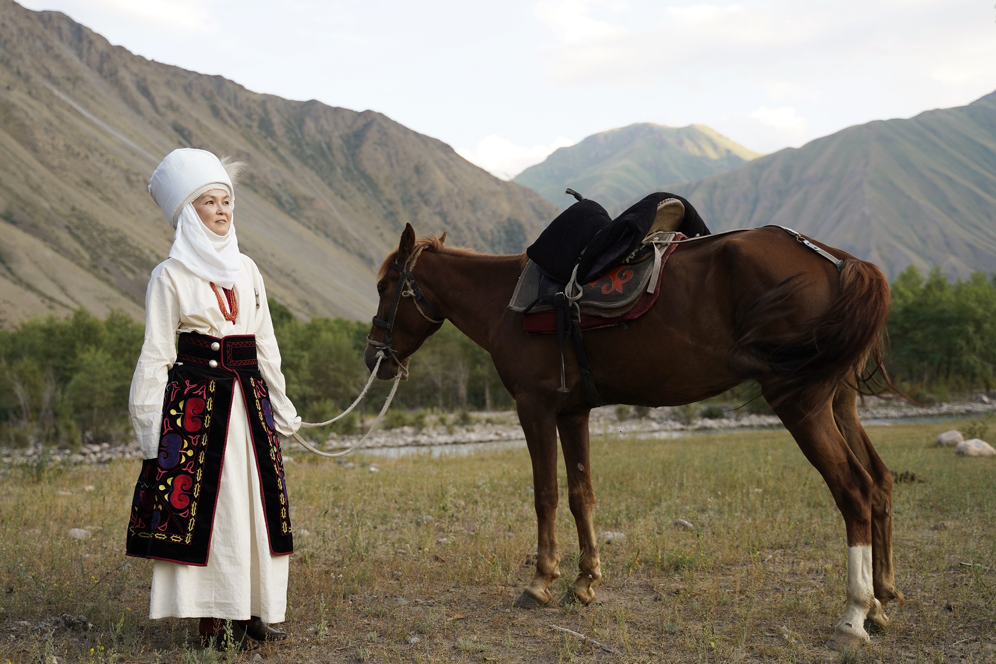 Woman with her horse in Kyrgyzstan