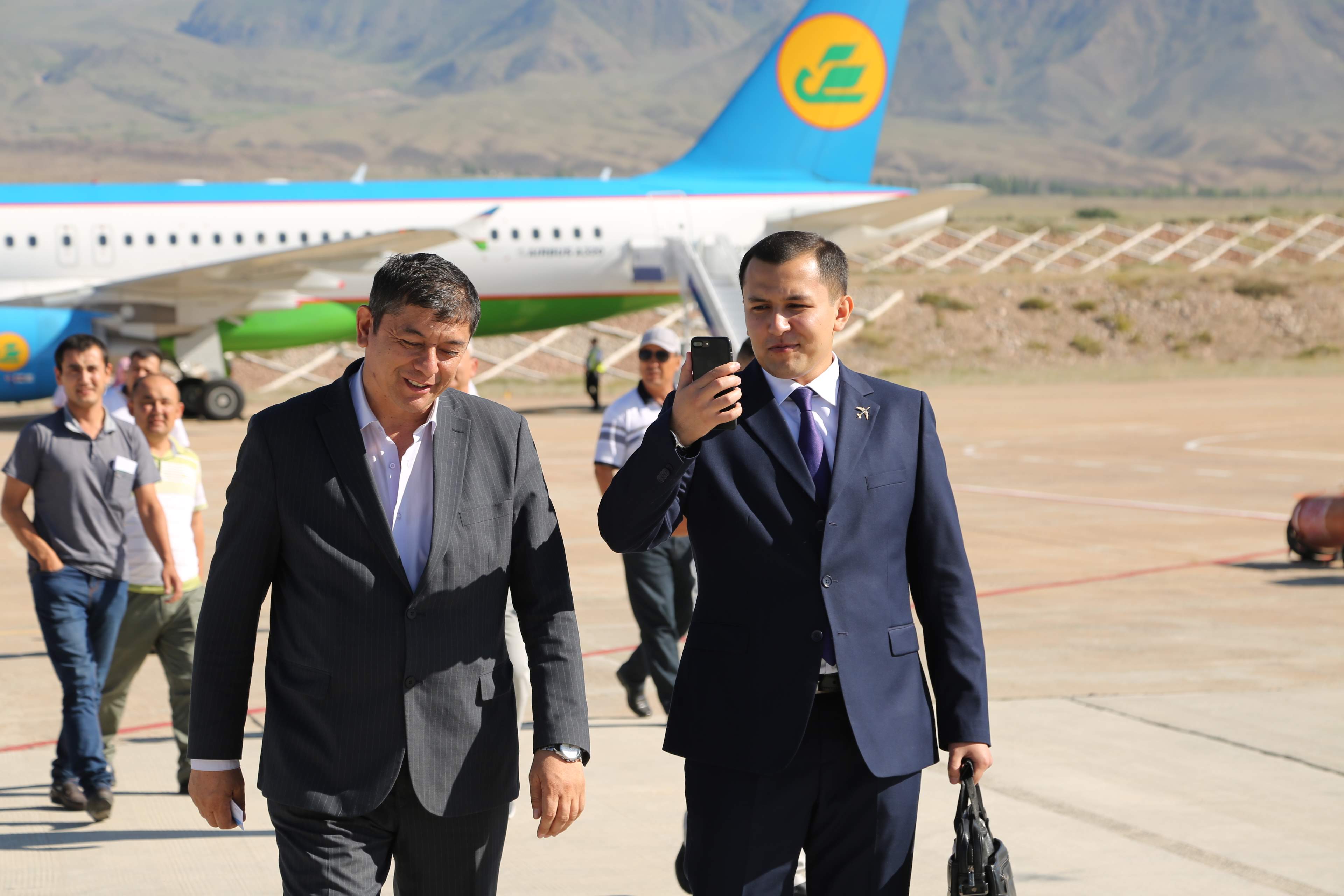 Kyrgyz Republic businessmen on cell phones