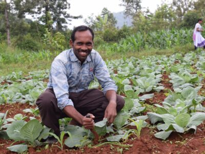 Man crouching in field